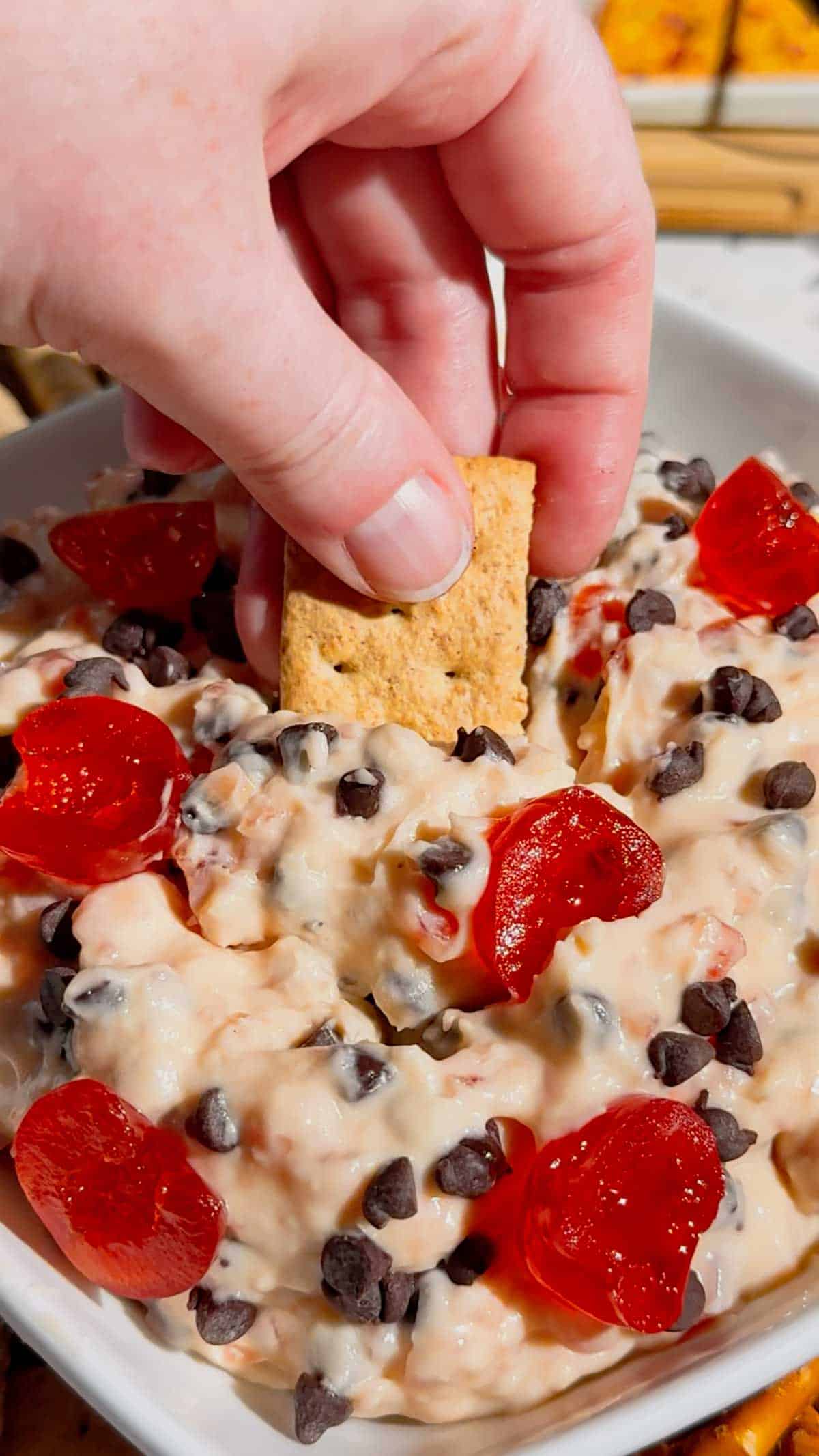Cherry Chocolate Chip Dip is an easy no bake dessert dip loaded with creamy cream cheese, sweet cherries and mini chocolate chips. This quick dessert dip takes just 15 minutes to make and is perfect for parties, holidays, potlucks, Valentine's Day treats and easy entertaining. If you love chocolate chip dip, cherry desserts, cheesecake dip and sweet cream cheese dip recipes, this simple party dessert is a must-try. Serve this cherry chocolate chip cheesecake dip with graham crackers, vanilla wafers, pretzels, cookies or fresh fruit for dipping. Made with cream cheese, butter, brown sugar, vanilla, candied cherries and chocolate chips, it's a rich and creamy no bake treat. Save this easy dessert dip recipe for your next party, holiday dessert table, girls' night or last-minute sweet treat!
