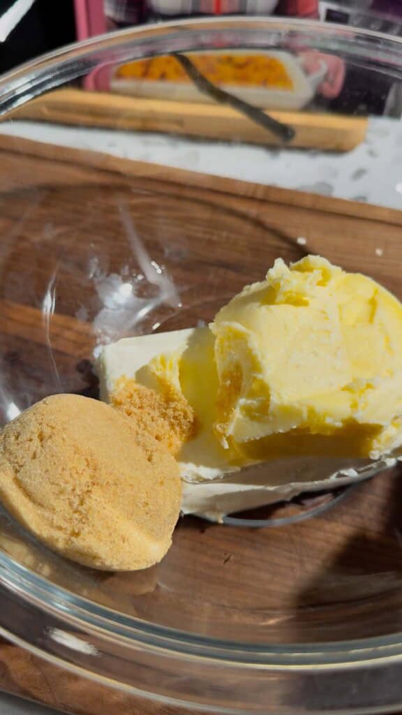 cream cheese, butter and brown sugar in a glass mixing bowl