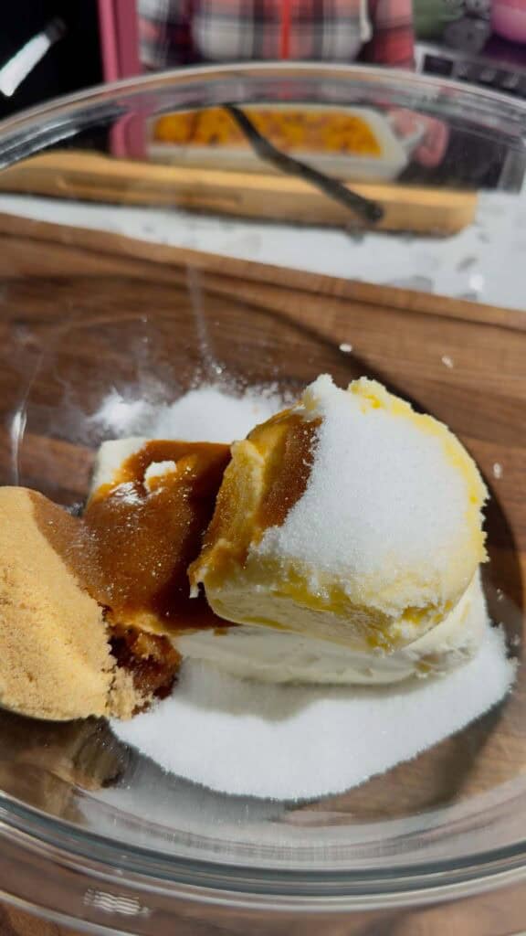 sugar, vanilla extract, softened butter and cream cheese in a glass mixing bowl
