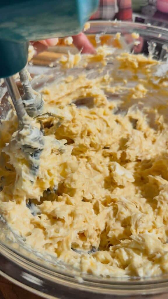creaming butter, sugar and cream cheese together in a glass mixing bowl
