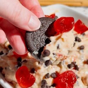 Cherry Chocolate Chip Dip is an easy no bake dessert dip loaded with creamy cream cheese, sweet cherries and mini chocolate chips. This quick dessert dip takes just 15 minutes to make and is perfect for parties, holidays, potlucks, Valentine's Day treats and easy entertaining. If you love chocolate chip dip, cherry desserts, cheesecake dip and sweet cream cheese dip recipes, this simple party dessert is a must-try. Serve this cherry chocolate chip cheesecake dip with graham crackers, vanilla wafers, pretzels, cookies or fresh fruit for dipping. Made with cream cheese, butter, brown sugar, vanilla, candied cherries and chocolate chips, it's a rich and creamy no bake treat. Save this easy dessert dip recipe for your next party, holiday dessert table, girls' night or last-minute sweet treat!
