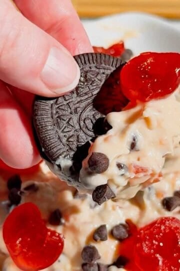 Cherry Chocolate Chip Dip is an easy no bake dessert dip loaded with creamy cream cheese, sweet cherries and mini chocolate chips. This quick dessert dip takes just 15 minutes to make and is perfect for parties, holidays, potlucks, Valentine's Day treats and easy entertaining. If you love chocolate chip dip, cherry desserts, cheesecake dip and sweet cream cheese dip recipes, this simple party dessert is a must-try. Serve this cherry chocolate chip cheesecake dip with graham crackers, vanilla wafers, pretzels, cookies or fresh fruit for dipping. Made with cream cheese, butter, brown sugar, vanilla, candied cherries and chocolate chips, it's a rich and creamy no bake treat. Save this easy dessert dip recipe for your next party, holiday dessert table, girls' night or last-minute sweet treat!