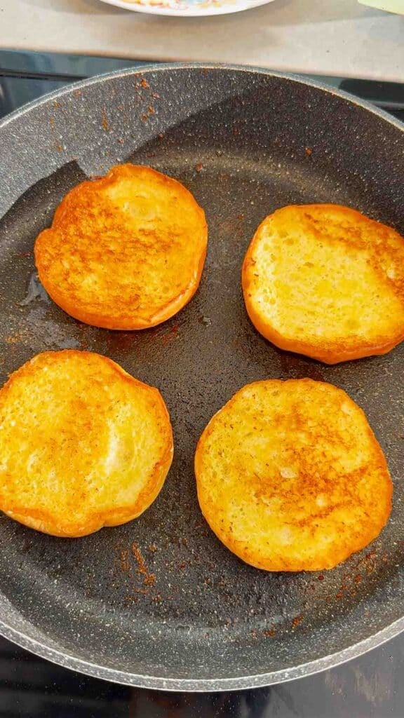 toast burger buns in a skillet