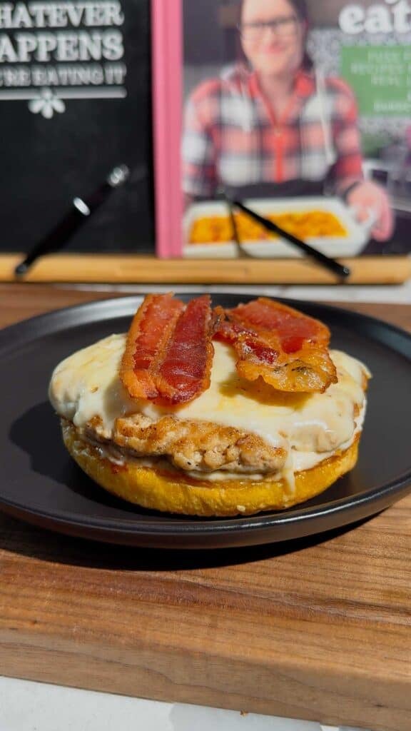 bacon strips on top of chicken patty on a bun