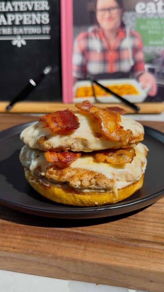 chicken patties and bacon strips on a burger bun