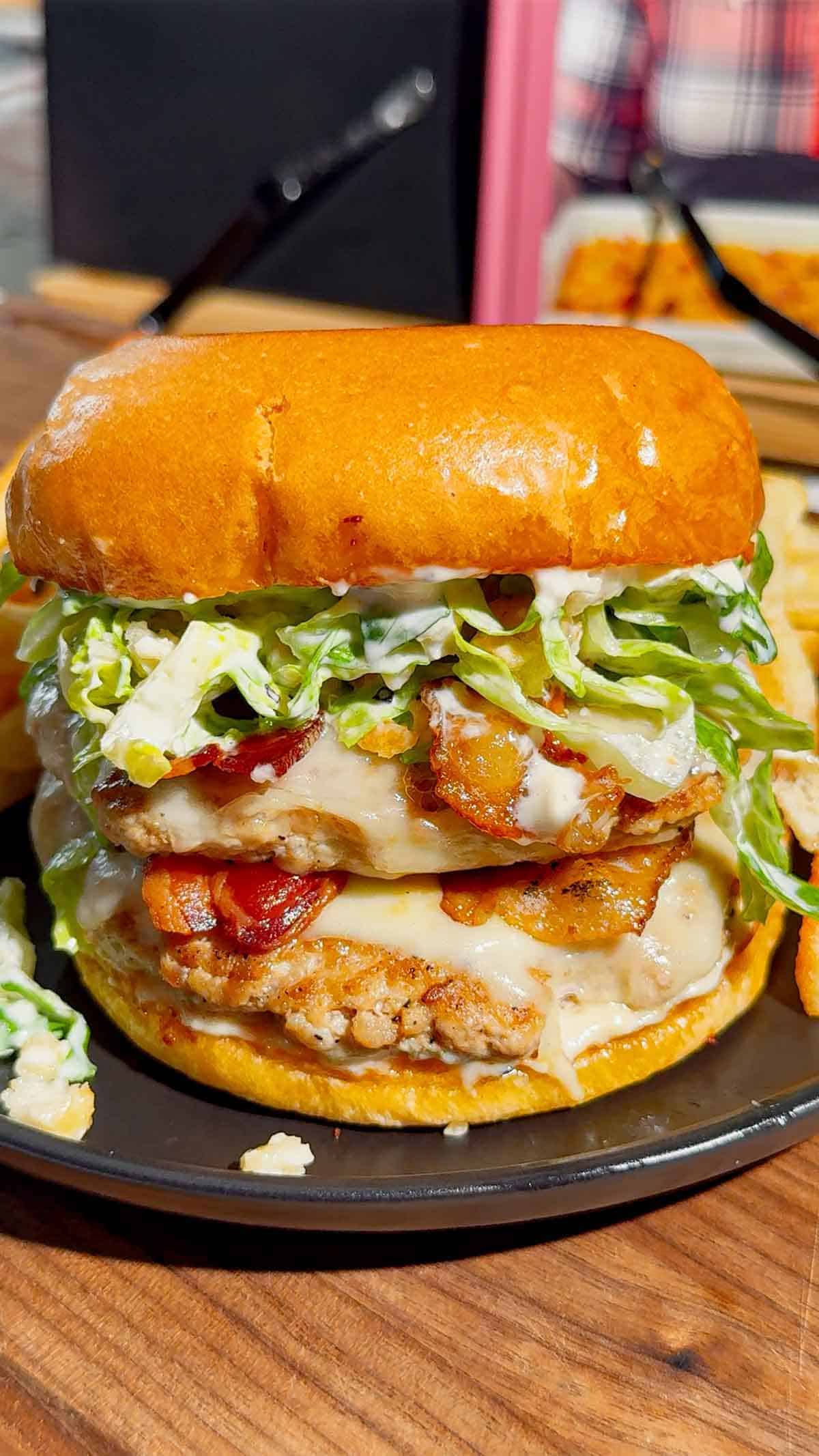 These Chicken Caesar Smash Burgers are the ultimate mashup of a juicy chicken burger and a classic Caesar salad. Made with crispy smashed ground chicken patties, melty mozzarella cheese, smoky bacon, creamy Caesar dressing, crunchy romaine lettuce, parmesan, and croutons on buttery toasted brioche buns, this easy burger recipe is perfect for weeknight dinners, summer cookouts, backyard BBQs, and family meals. If you're looking for smash burger recipes, chicken burger recipes, ground chicken recipes, easy dinner ideas, burger night inspiration, or restaurant-style burgers you can make at home, this Chicken Caesar Smash Burger recipe delivers big flavor with simple ingredients. Save this easy chicken smash burger recipe for your next cookout, game day, or quick dinner everyone will rave about!