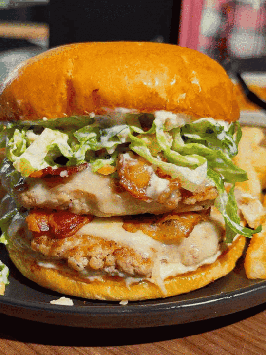 These Chicken Caesar Smash Burgers are the ultimate mashup of a juicy chicken burger and a classic Caesar salad. Made with crispy smashed ground chicken patties, melty mozzarella cheese, smoky bacon, creamy Caesar dressing, crunchy romaine lettuce, parmesan, and croutons on buttery toasted brioche buns, this easy burger recipe is perfect for weeknight dinners, summer cookouts, backyard BBQs, and family meals. If you're looking for smash burger recipes, chicken burger recipes, ground chicken recipes, easy dinner ideas, burger night inspiration, or restaurant-style burgers you can make at home, this Chicken Caesar Smash Burger recipe delivers big flavor with simple ingredients. Save this easy chicken smash burger recipe for your next cookout, game day, or quick dinner everyone will rave about!