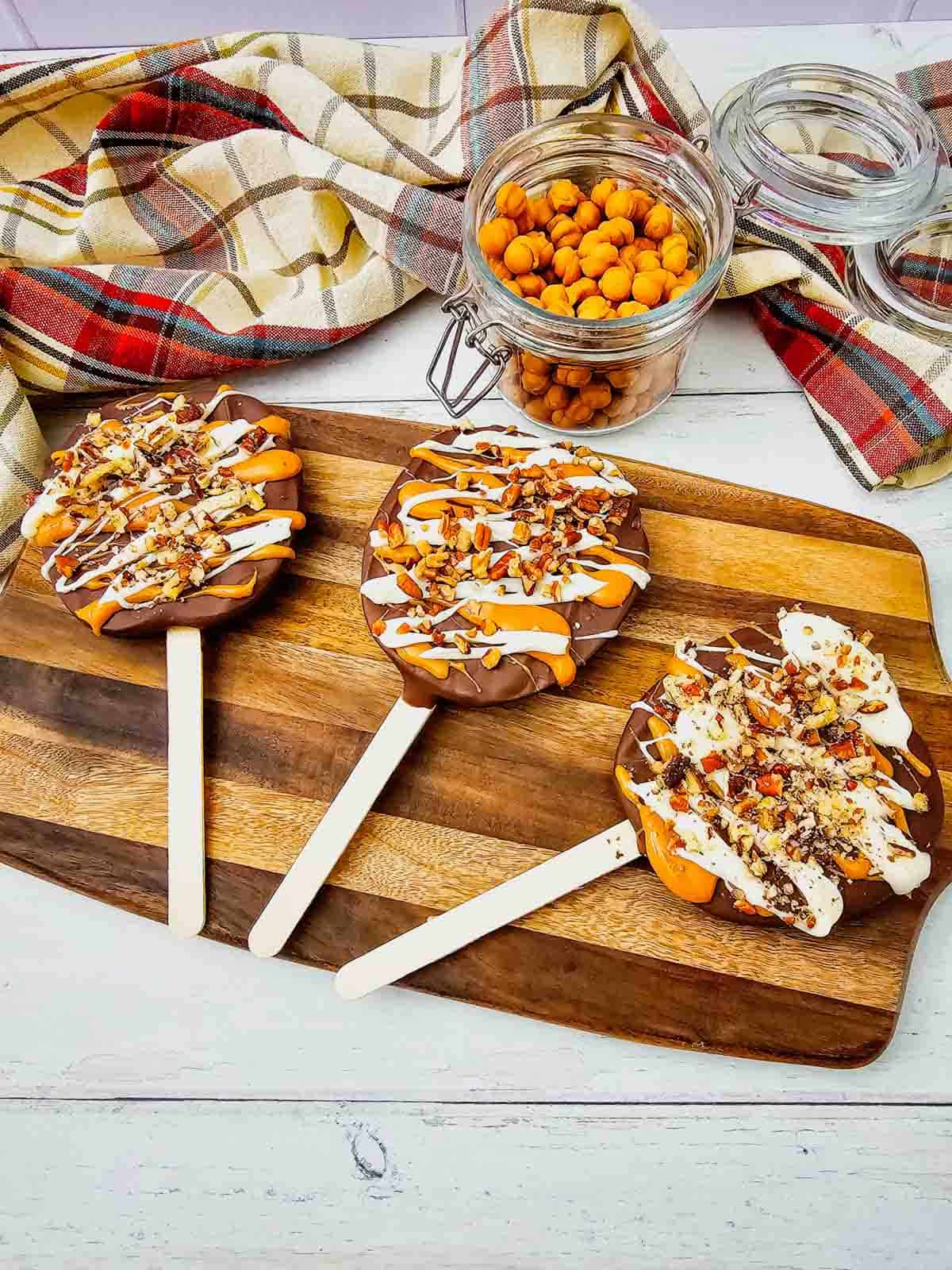 These Chocolate Caramel Apple Slice Pops are an easy fall treat combining crisp Granny Smith apples with rich chocolate, gooey caramel, white chocolate drizzle, and crunchy pecans. If you love Caramel Apple Slices, Chocolate Covered Apple Slices, or classic Caramel Apples, this simple recipe is a must-try. These Apple Slice Pops are perfect for Fall Desserts, Halloween Treats, Thanksgiving Desserts, Fall Party Food. Learn How To Make Chocolate Covered Apples with an easy twist that is less messy than whole apples. These Chocolate Caramel Apples are sweet, tart, and crunchy in every bite. Save this Easy Fall Dessert Recipe for apple season, Halloween parties, Thanksgiving, or anytime you need Easy Apple Desserts, Fall Treat Ideas, or a fun No Bake Dessert everyone will love.