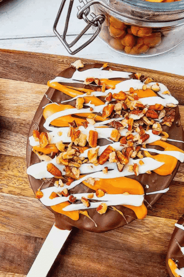 These Chocolate Caramel Apple Slice Pops are an easy fall treat combining crisp Granny Smith apples with rich chocolate, gooey caramel, white chocolate drizzle, and crunchy pecans. If you love Caramel Apple Slices, Chocolate Covered Apple Slices, or classic Caramel Apples, this simple recipe is a must-try. These Apple Slice Pops are perfect for Fall Desserts, Halloween Treats, Thanksgiving Desserts, Fall Party Food. Learn How To Make Chocolate Covered Apples with an easy twist that is less messy than whole apples. These Chocolate Caramel Apples are sweet, tart, and crunchy in every bite. Save this Easy Fall Dessert Recipe for apple season, Halloween parties, Thanksgiving, or anytime you need Easy Apple Desserts, Fall Treat Ideas, or a fun No Bake Dessert everyone will love.