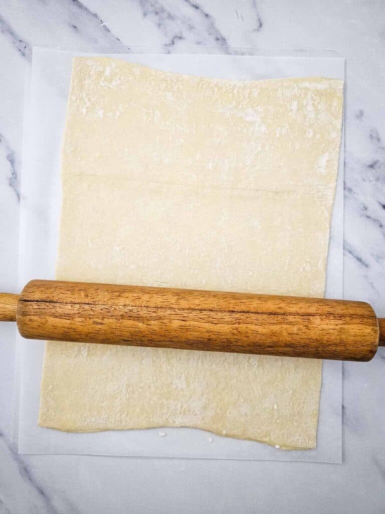 puff pastry rolled out on the kitchen counter