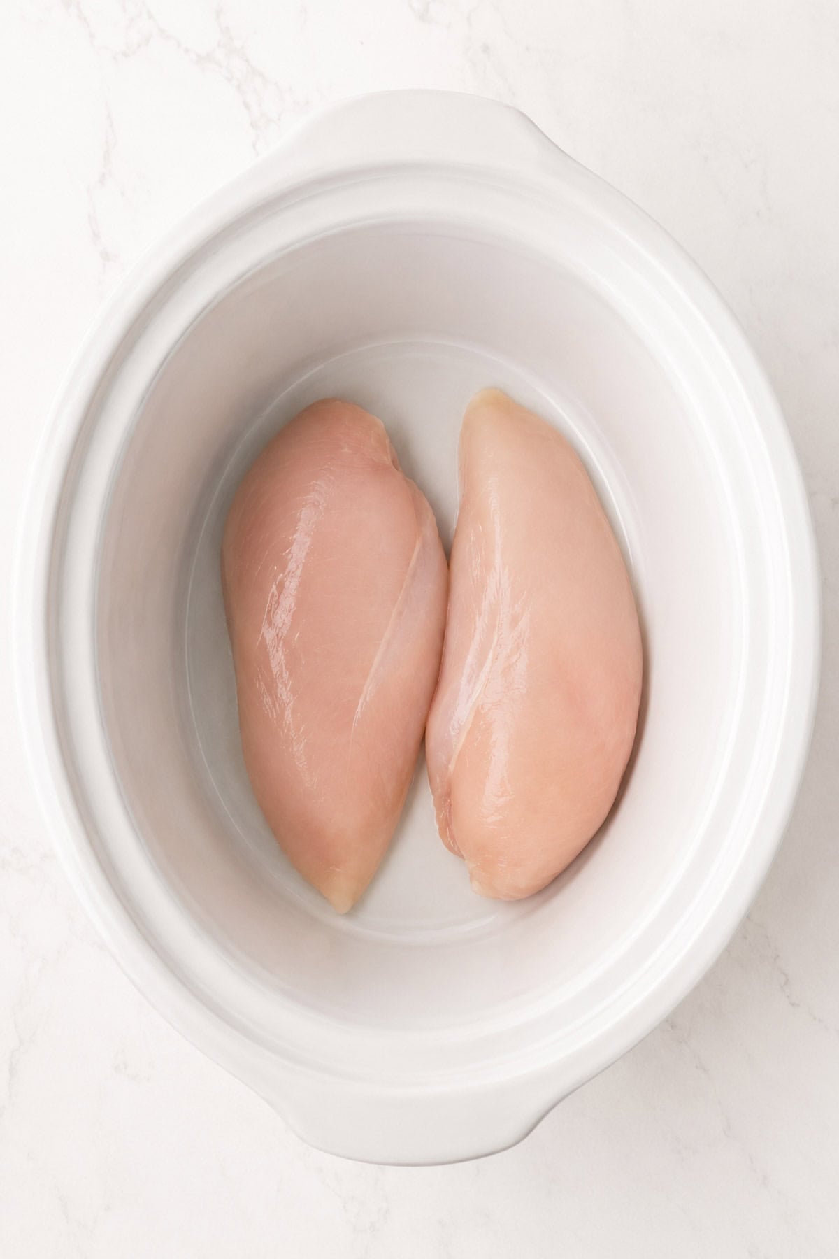 boneless skinless chicken breasts in the bottom of a slow cooker