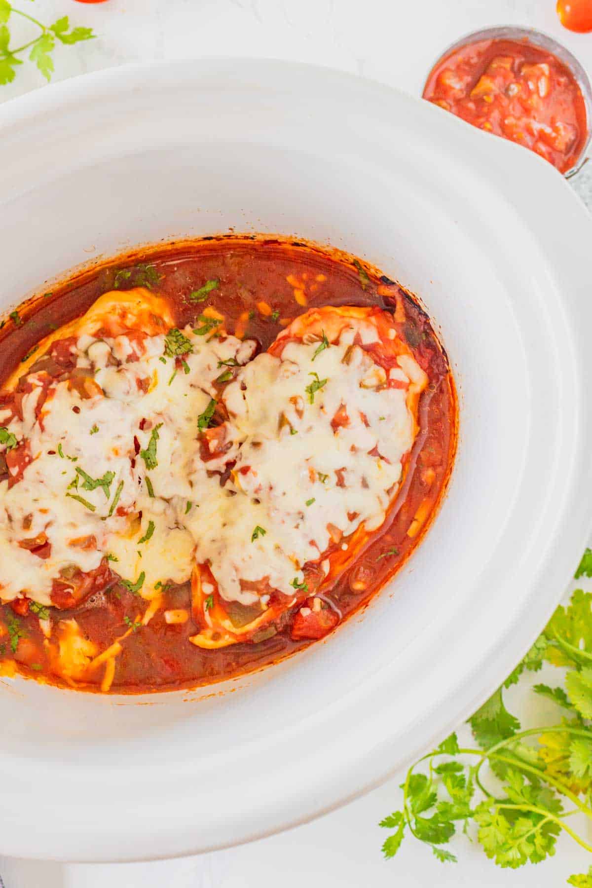 This Crockpot Chicken Salsa is an easy slow cooker dinner for busy weeknights! Tender chicken breasts cook low and slow with flavorful salsa, then get topped with melty Monterey Jack cheese for a simple meal the whole family will love. This easy salsa chicken recipe uses just a handful of ingredients and is perfect for tacos, burrito bowls, rice bowls, nachos, or serving with Mexican-inspired side dishes. If you love easy crockpot chicken recipes, slow cooker salsa chicken, dump and go dinners, simple chicken breast recipes, and family friendly meals, this one belongs on your menu. Customize it with spicy salsa, jalapeños, corn, peppers, avocado, sour cream, cilantro, or lime. Save this Crockpot Salsa Chicken recipe for an easy weeknight dinner, meal prep lunch, or fuss-free family meal!