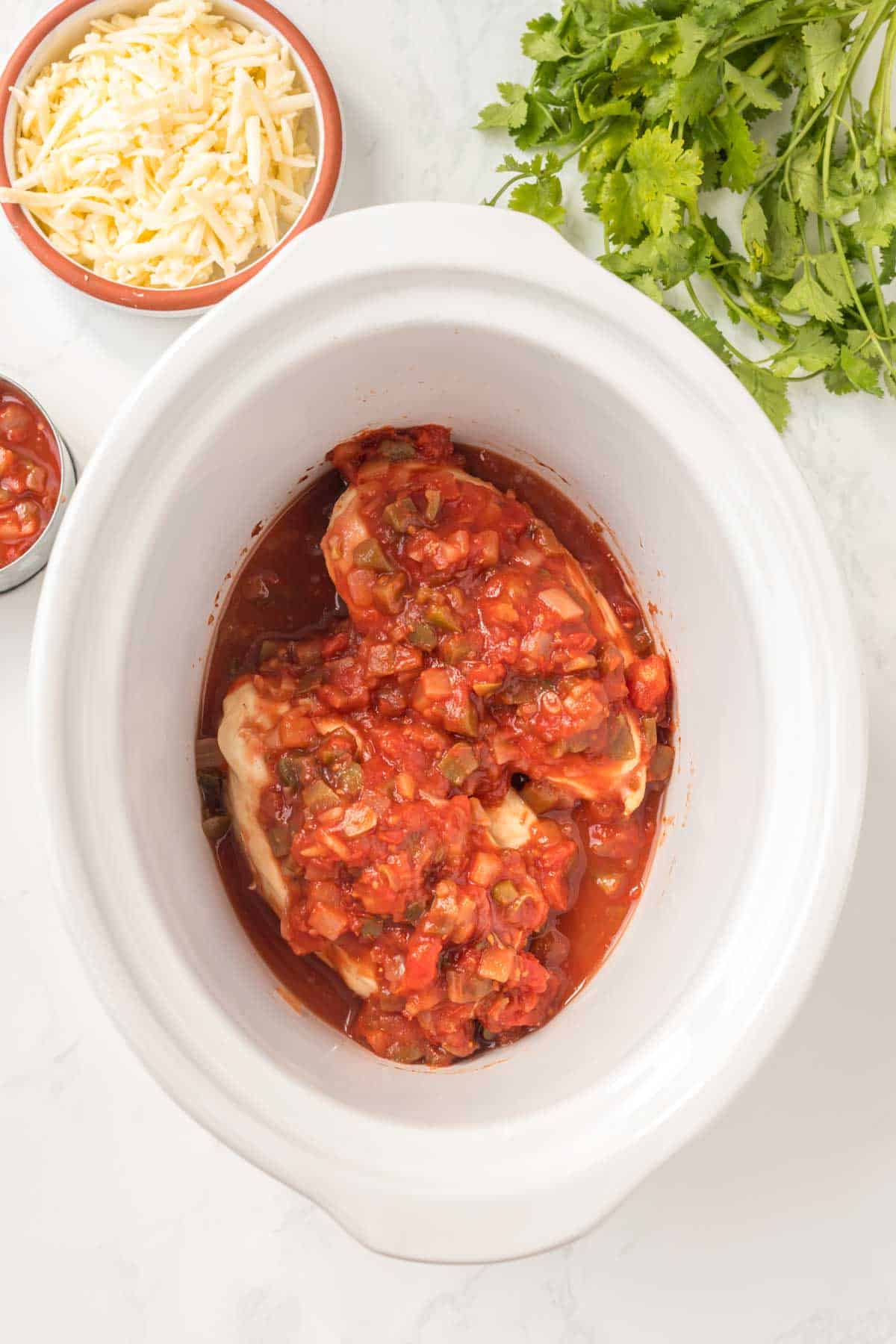 cooked salsa chicken breasts in a slow cooker