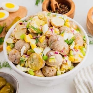 This Dill Pickle Potato Salad is the ultimate creamy and tangy summer side dish for pickle lovers! Tender baby potatoes are tossed with crunchy dill pickles, crisp celery, red onion, fresh dill, and chopped hard-boiled eggs for a flavor-packed twist on Classic Potato Salad. A creamy dressing made with mayonnaise, dill pickle juice, yellow mustard, and red wine vinegar gives this Easy Potato Salad Recipe plenty of zippy pickle flavor. Serve this Dill Pickle Potato Salad Recipe at summer BBQs, backyard cookouts, picnics, potlucks, family dinners, or holiday gatherings. If you're searching for Easy Summer Side Dishes, BBQ Side Dishes, Cold Potato Salad Recipes, Dill Pickle Recipes, Picnic Side Dishes, or the Best Potato Salad Recipe, save this creamy potato salad for later!