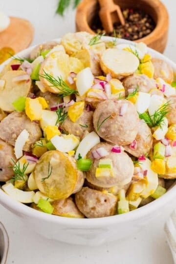 This Dill Pickle Potato Salad is the ultimate creamy and tangy summer side dish for pickle lovers! Tender baby potatoes are tossed with crunchy dill pickles, crisp celery, red onion, fresh dill, and chopped hard-boiled eggs for a flavor-packed twist on Classic Potato Salad. A creamy dressing made with mayonnaise, dill pickle juice, yellow mustard, and red wine vinegar gives this Easy Potato Salad Recipe plenty of zippy pickle flavor. Serve this Dill Pickle Potato Salad Recipe at summer BBQs, backyard cookouts, picnics, potlucks, family dinners, or holiday gatherings. If you're searching for Easy Summer Side Dishes, BBQ Side Dishes, Cold Potato Salad Recipes, Dill Pickle Recipes, Picnic Side Dishes, or the Best Potato Salad Recipe, save this creamy potato salad for later!