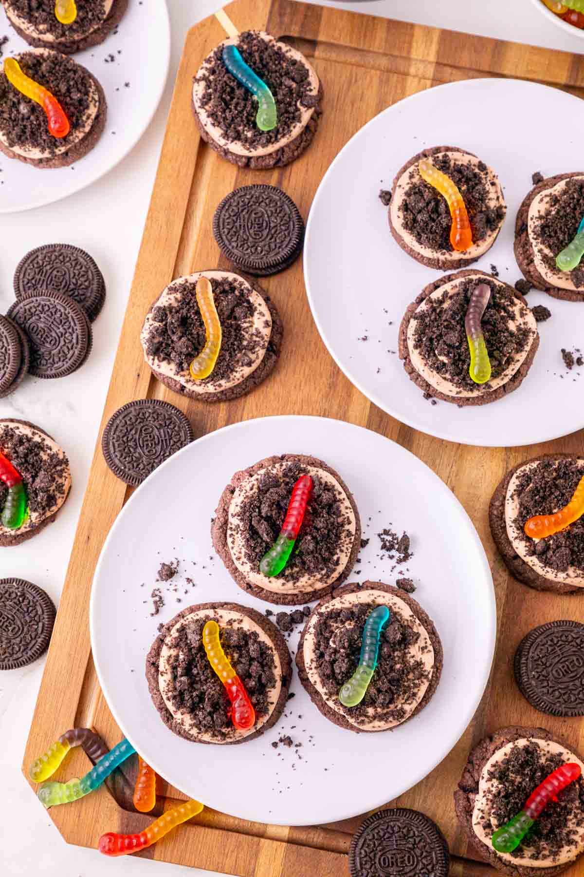 These Dirt and Worms Cookies are the ultimate fun and easy Halloween dessert for kids and adults! Rich chocolate cookies are topped with creamy Nutella frosting, crushed Oreo cookie “dirt,” and colorful gummy worms for a spooky treat that’s almost too cute to eat. If you’re searching for Halloween Cookies, Halloween Dessert Recipes, Spooky Cookies, Dirt and Worm Cookies, Gummy Worm Desserts, Oreo Desserts, or Easy Halloween Treats, save this recipe! These creepy-cute cookies are perfect for Halloween Party Food, Halloween Baking Ideas Easy, Halloween Food For Party, Halloween Treats For Kids, Spooky Halloween Desserts, Halloween Cookie Ideas, and fun classroom treats. With store bought cookie dough and simple decorating, these easy Halloween cookies come together quickly for parties, movie nights, and October celebrations.