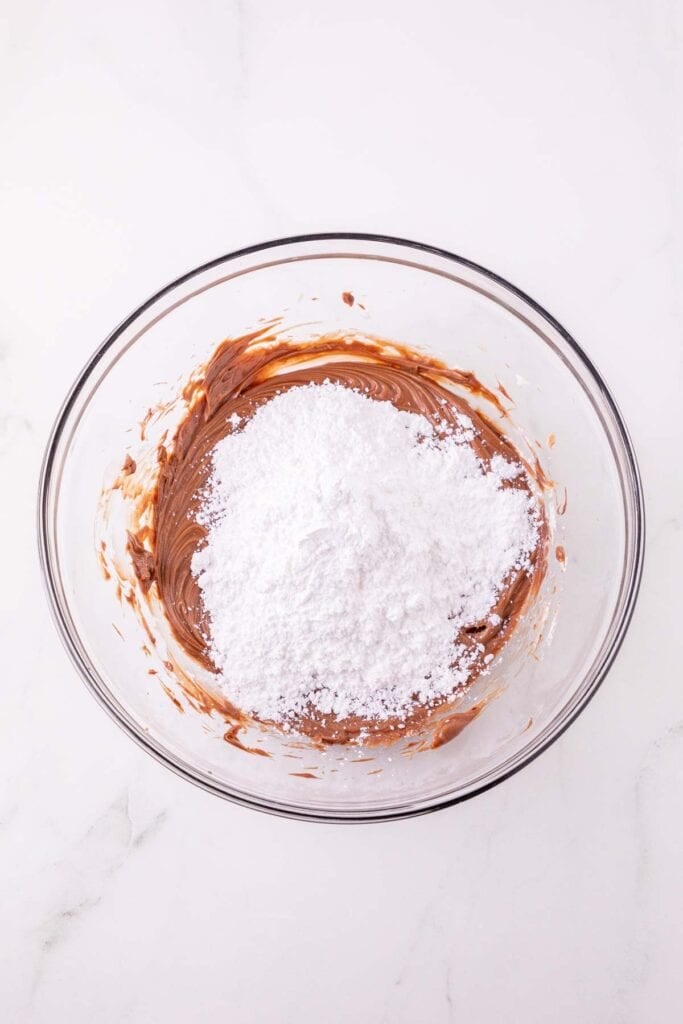 icing sugar and nutella in a mixing bowl