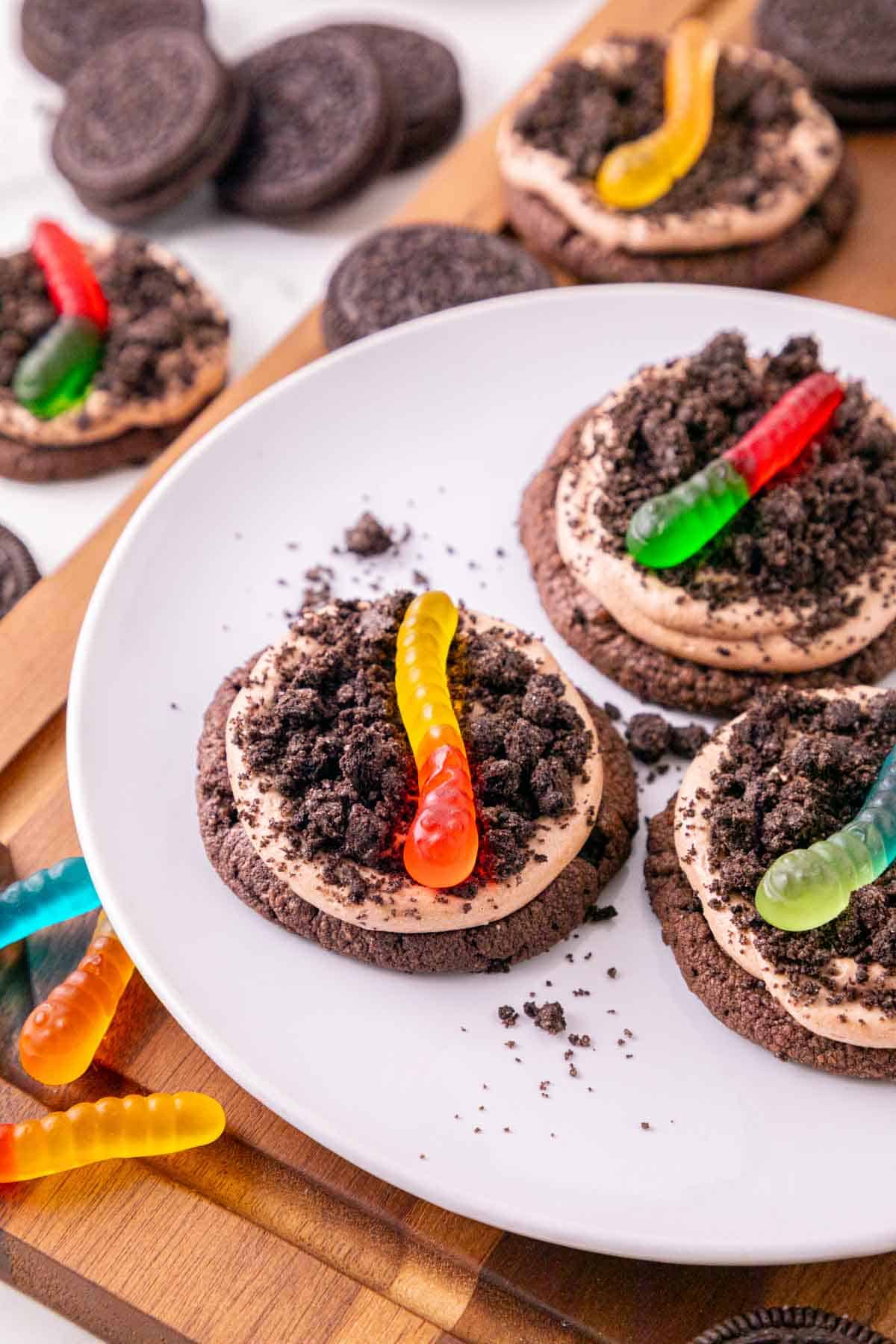 These Dirt and Worms Cookies are the ultimate fun and easy Halloween dessert for kids and adults! Rich chocolate cookies are topped with creamy Nutella frosting, crushed Oreo cookie “dirt,” and colorful gummy worms for a spooky treat that’s almost too cute to eat. If you’re searching for Halloween Cookies, Halloween Dessert Recipes, Spooky Cookies, Dirt and Worm Cookies, Gummy Worm Desserts, Oreo Desserts, or Easy Halloween Treats, save this recipe! These creepy-cute cookies are perfect for Halloween Party Food, Halloween Baking Ideas Easy, Halloween Food For Party, Halloween Treats For Kids, Spooky Halloween Desserts, Halloween Cookie Ideas, and fun classroom treats. With store bought cookie dough and simple decorating, these easy Halloween cookies come together quickly for parties, movie nights, and October celebrations.
