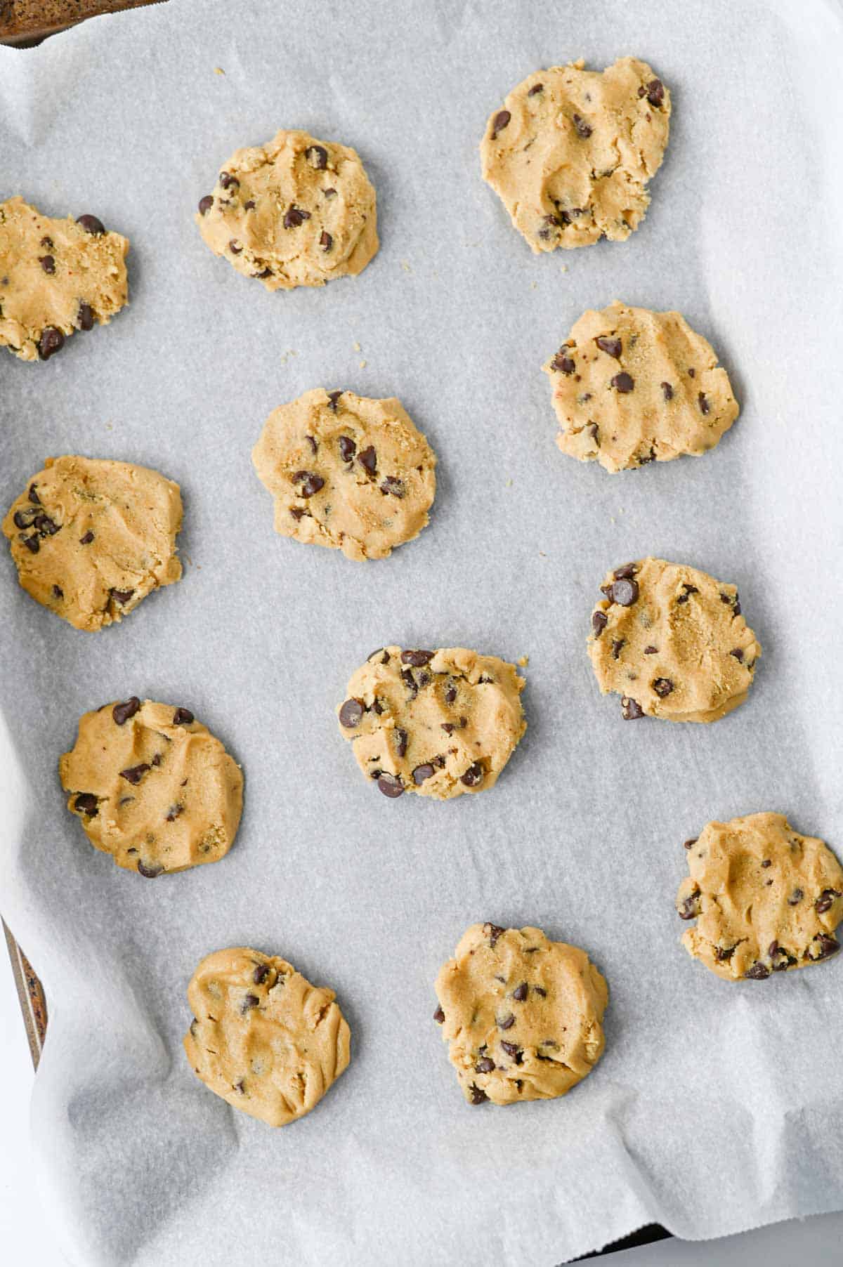 chocolate chip cookie dough on a parchment lined baking sheet