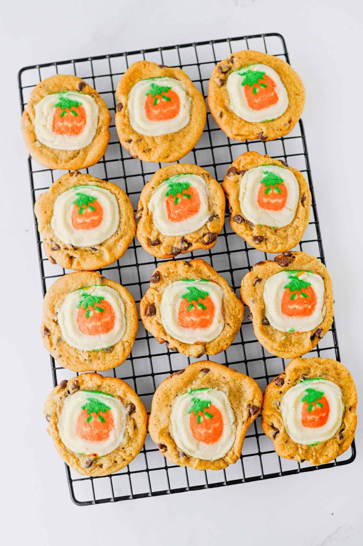 These Easy Halloween Cookies are the ultimate spooky season treat when you need something cute, festive, and incredibly simple! Made with just two ingredients, these Halloween cookies combine classic chocolate chip cookie dough with Pillsbury Pumpkin Shaped Cookies for an adorable two-in-one dessert. If you're searching for Easy Halloween Cookies, Halloween Cookie Ideas, Halloween Treats For Kids, Pillsbury Halloween Cookies, Easy Halloween Desserts, Fall Cookie Recipes, Pumpkin Cookies, or Halloween Party Food, you'll love this shortcut recipe. They bake in just 10 minutes and are perfect for Halloween parties, school treats, fall gatherings, movie nights, and October baking with kids. Save these easy Halloween cookies for a fun spooky treat everyone will love!