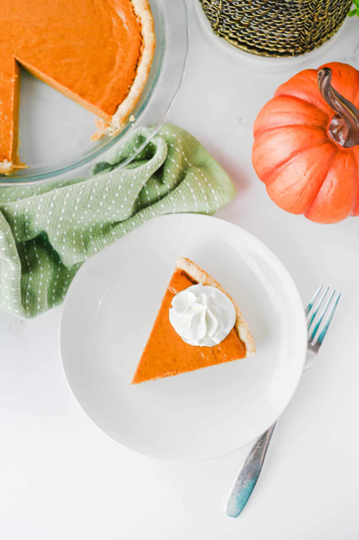 This Easy Pumpkin Pie Recipe is the perfect classic fall dessert for Thanksgiving, Christmas, or any cozy autumn gathering! Made with pumpkin puree, sweetened condensed milk, eggs, pumpkin pie spice, and a convenient store bought pie crust, this Homemade Pumpkin Pie is incredibly simple to prepare. If you're looking for Easy Pumpkin Desserts, Thanksgiving Pie Recipes, Pumpkin Puree Recipes, or Fall Baking Ideas, this creamy pie is a must-try. The smooth Pumpkin Pie Filling is warmly spiced and bakes up perfectly in a flaky golden crust. It's an Easy Thanksgiving Dessert that's great for beginner bakers and holiday entertaining. Save this Classic Pumpkin Pie Recipe for your Thanksgiving menu, fall baking list, or whenever you're craving an Easy Pumpkin Dessert that's rich, creamy, and full of pumpkin spice flavor!
