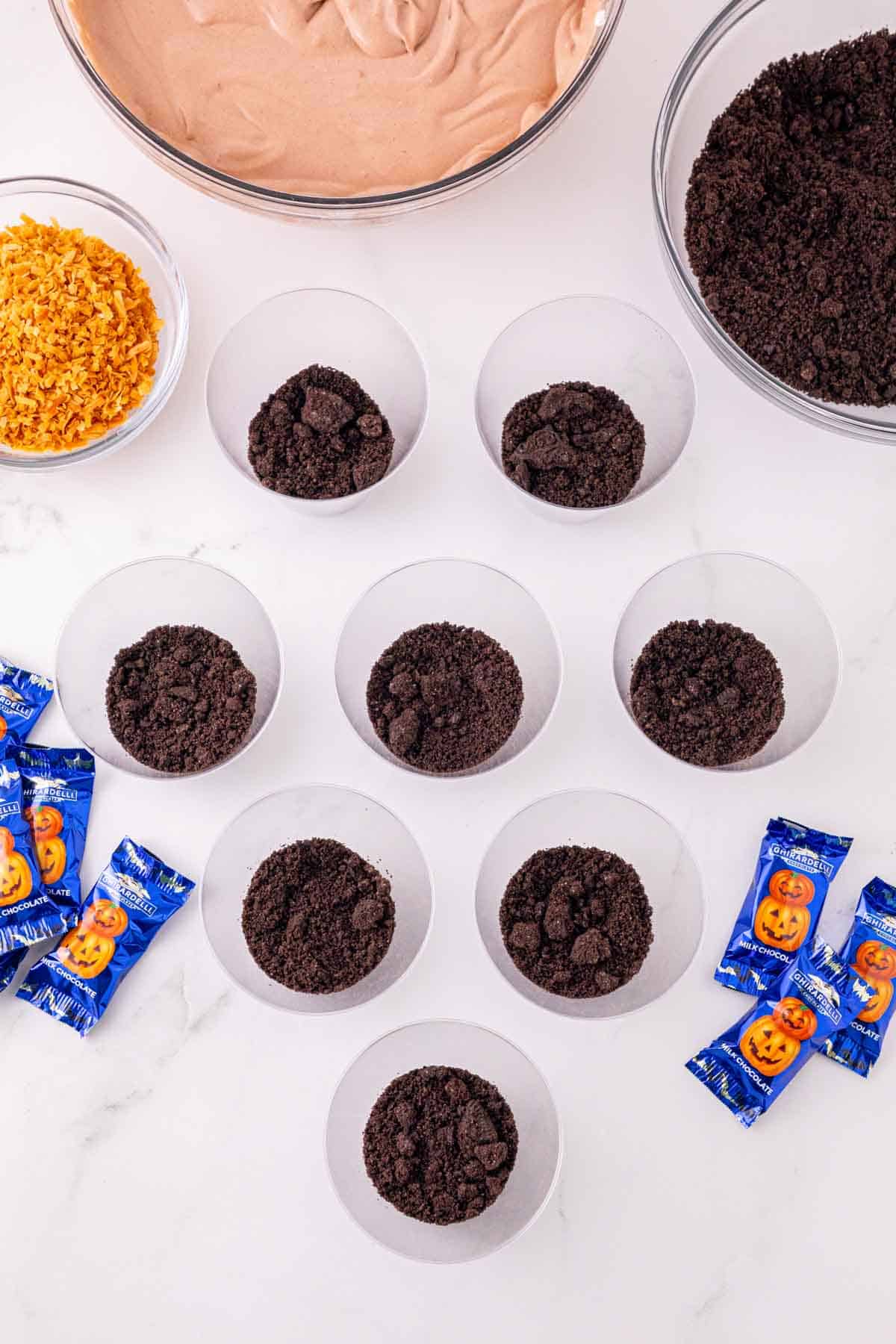 crumbled oreos in the bottom of clear cups