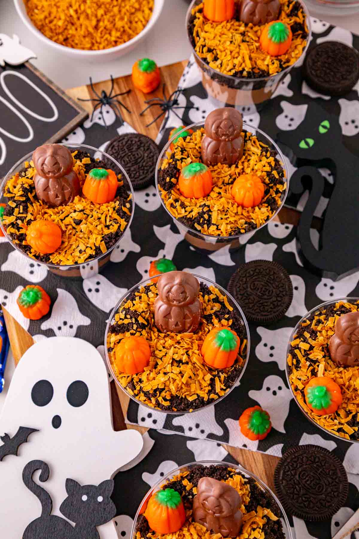 These Halloween Dirt Cups are an easy no bake Halloween dessert perfect for parties, kids, and spooky season celebrations! Creamy chocolate peanut butter pudding is layered with crushed Oreo cookies to create delicious Oreo dirt cups, then topped with toasted coconut, mellowcreme pumpkins, and jack o lantern chocolates. If you need easy Halloween desserts, Halloween party food, Halloween treats for kids, or fun Halloween dessert ideas, these pudding dirt cups are a must-try. These Halloween pudding cups take just 15 minutes to prepare and are served in individual cups for an easy party dessert. Make these spooky dirt cups for a Halloween party, school celebration, fall gathering, or movie night. They're a fun twist on classic Oreo dirt pudding and an easy Halloween treat everyone will want to dig into!