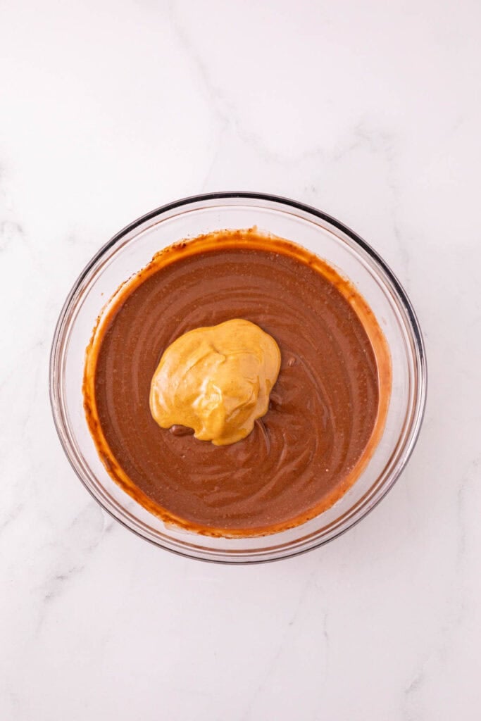 peanut butter added to mixing bowl with chocolate pudding