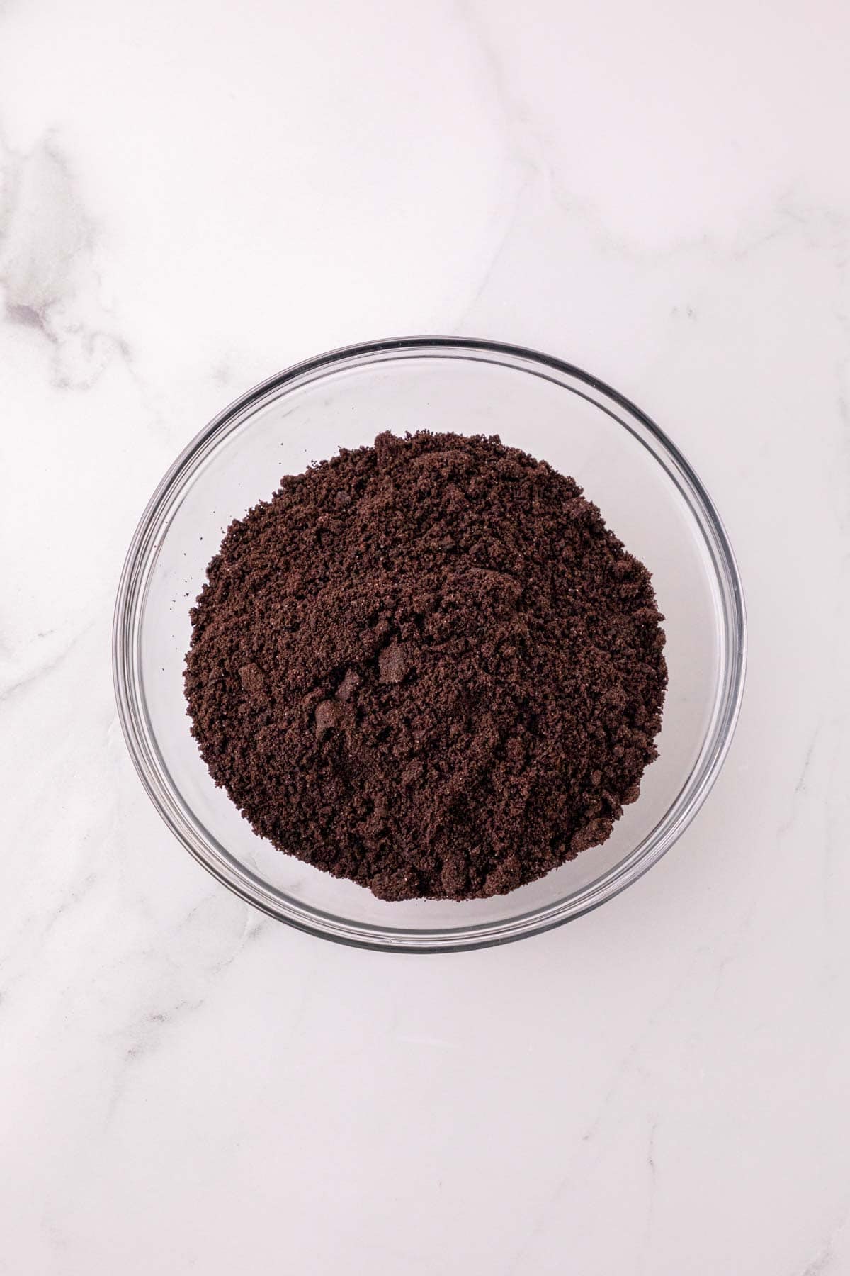 crumbled oreos in the bottom of a cup