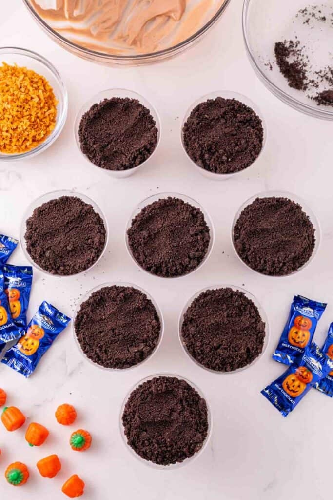 oreo layer on top of pudding in clear plastic cups