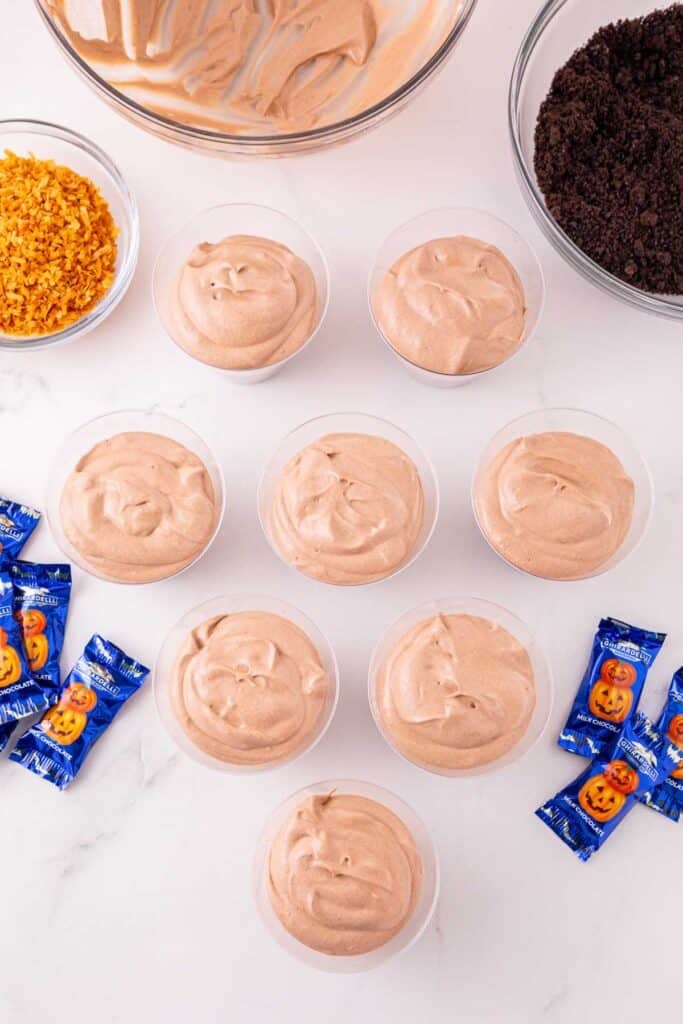 chocolate peanut butter pudding mixture in a clear plastic cups