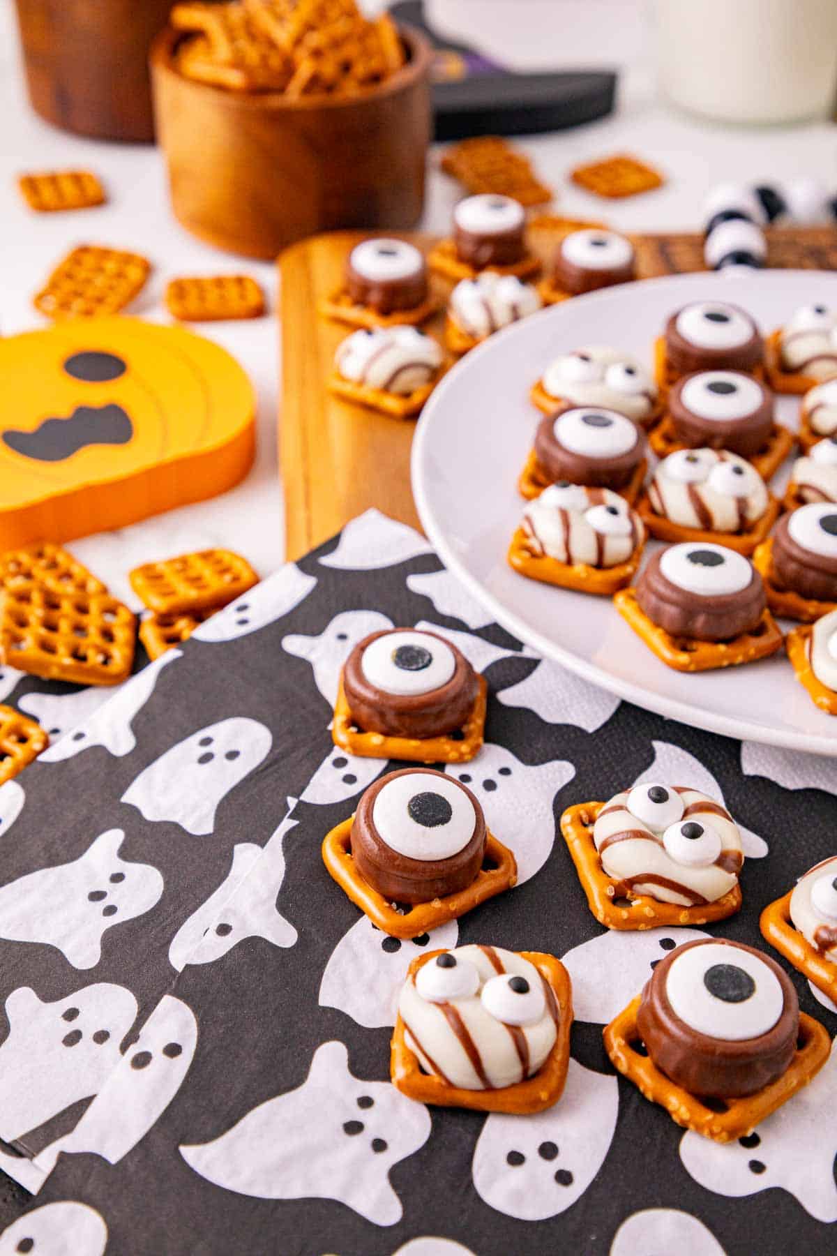 These Halloween Pretzel Rolo Bites are an easy Halloween treat made with crunchy pretzels, gooey Rolo chocolates, Hershey’s Hugs and spooky candy eyes! If you need Easy Halloween Treats, Halloween Pretzel Treats, Halloween Party Food, Halloween Snacks for Kids or quick No Fuss Halloween Desserts, these sweet and salty bites are perfect. They’re ready with just 10 minutes of prep and 3 minutes in the oven, making them a fun choice for Halloween Party Snacks, Classroom Halloween Treats, Halloween Candy Treats and Spooky Halloween Food. Add candy eyeballs to create creepy monster pretzel bites with melted chocolate and caramel. Save these Rolo Pretzel Bites for Halloween Baking Ideas, Easy Halloween Desserts, Kids Halloween Snacks, Halloween Finger Foods and simple Halloween Party Treats everyone will love!