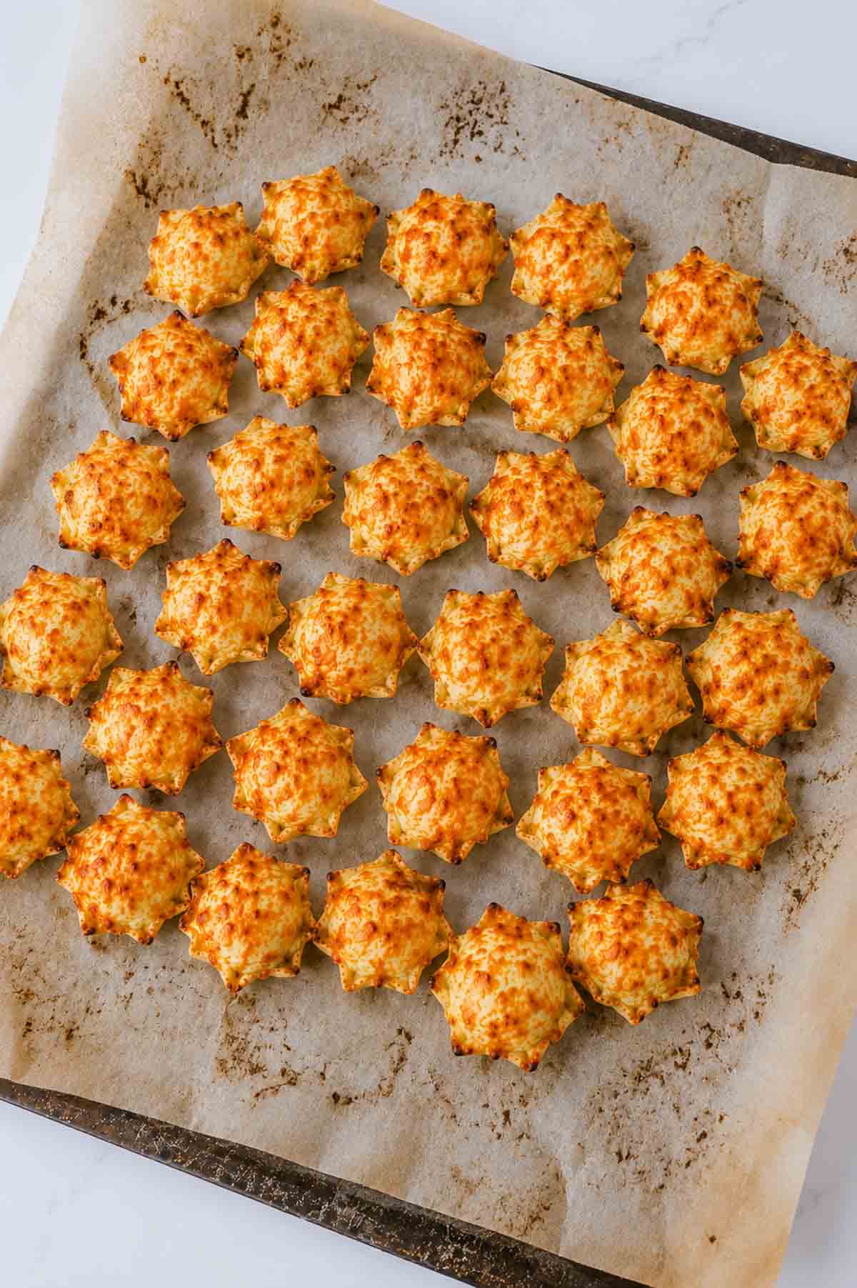 baked iowa party bites on a parchment lined baking sheet