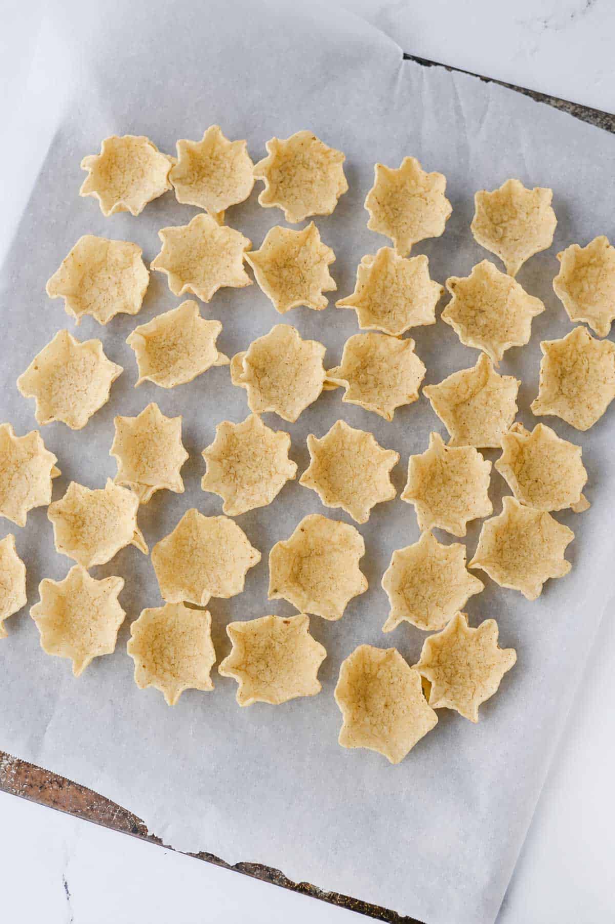 tostitos scoops on a parchment lined baking sheet