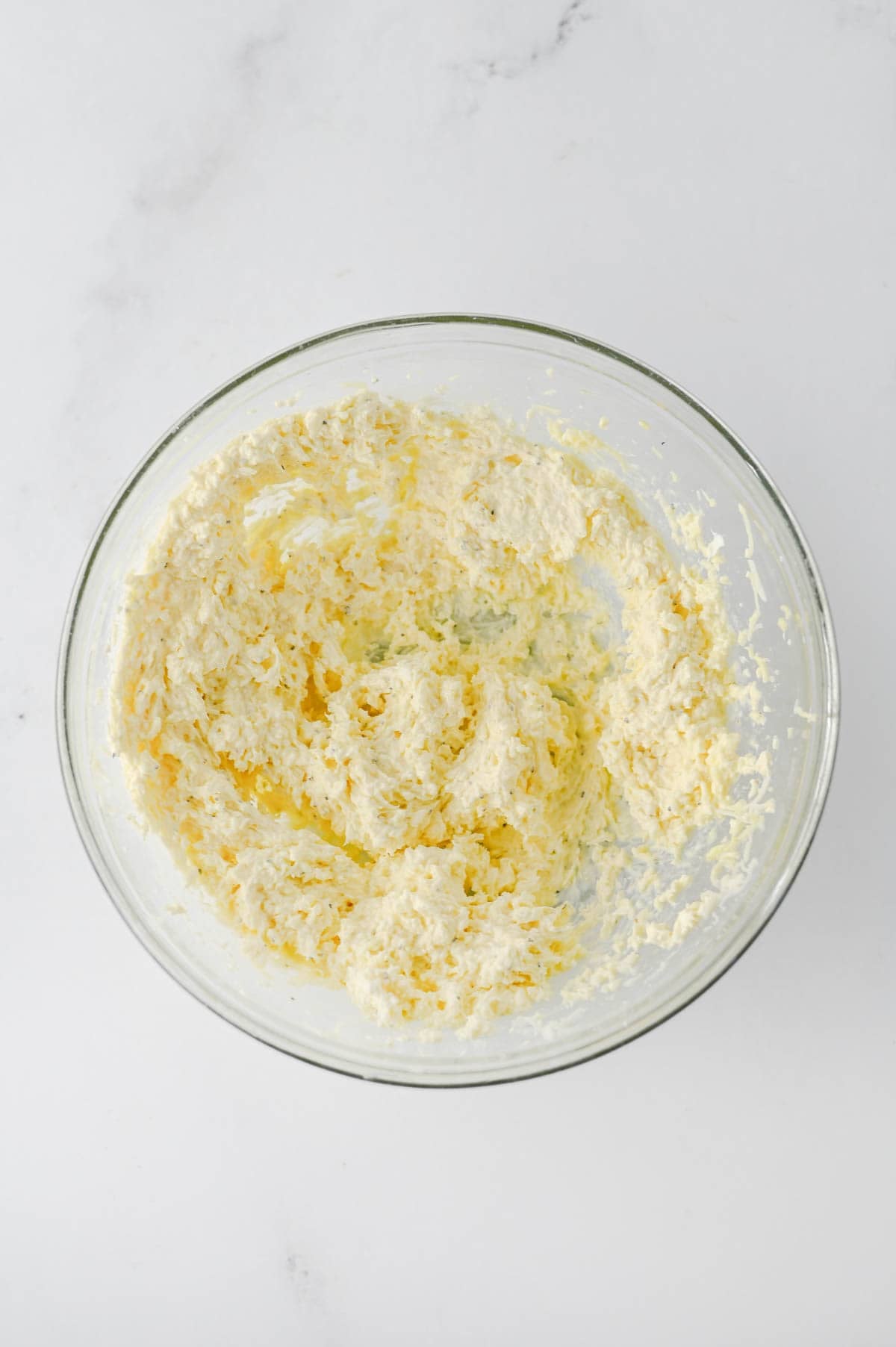 cream, cheese, egg and shredded cheese mixture in a mixing bowl