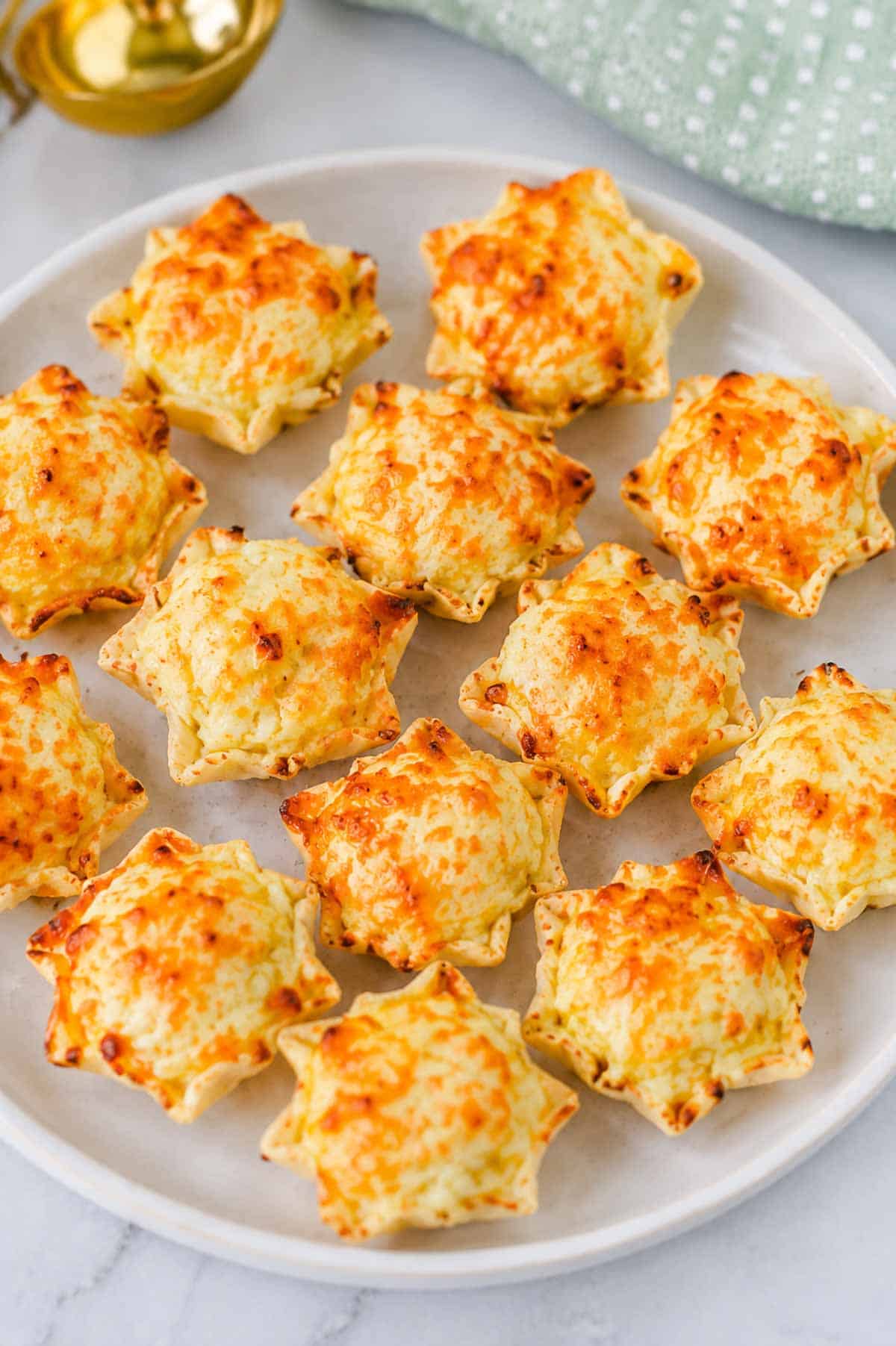 These Iowa Party Bites are the ultimate easy appetizer for game day, holiday parties, potlucks, and family gatherings! Crispy Tostitos Scoops are filled with a creamy, cheesy mixture of cream cheese, mozzarella, sweet corn, green chiles, and savory seasonings, then topped with Parmesan and baked until golden and bubbly. This Iowa Party Bites Recipe is perfect when you need easy party appetizers, bite sized appetizers, finger foods, or quick game day snacks that everyone will grab by the handful. Add these cheesy corn bites to your favorite party food ideas, football appetizers, tailgate snacks, Super Bowl appetizers, or holiday appetizer recipes. With simple ingredients and just 15 minutes of baking time, these warm tortilla chip bites are an easy crowd pleasing appetizer for any occasion!