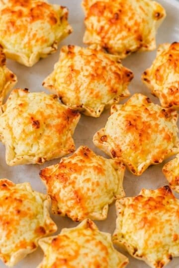 These Iowa Party Bites are the ultimate easy appetizer for game day, holiday parties, potlucks, and family gatherings! Crispy Tostitos Scoops are filled with a creamy, cheesy mixture of cream cheese, mozzarella, sweet corn, green chiles, and savory seasonings, then topped with Parmesan and baked until golden and bubbly. This Iowa Party Bites Recipe is perfect when you need easy party appetizers, bite sized appetizers, finger foods, or quick game day snacks that everyone will grab by the handful. Add these cheesy corn bites to your favorite party food ideas, football appetizers, tailgate snacks, Super Bowl appetizers, or holiday appetizer recipes. With simple ingredients and just 15 minutes of baking time, these warm tortilla chip bites are an easy crowd pleasing appetizer for any occasion!