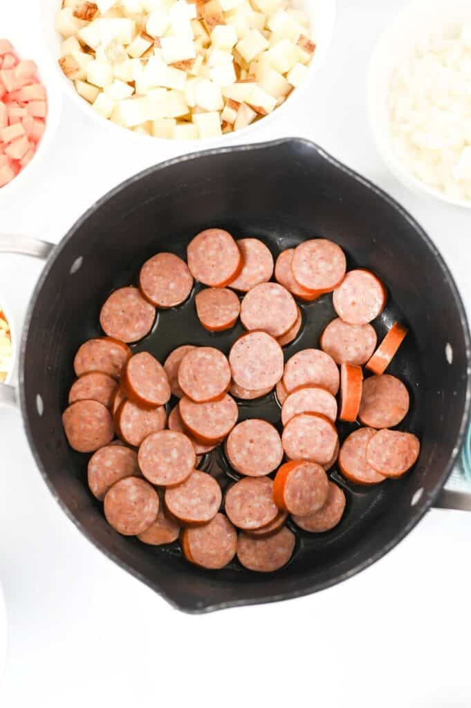 kielbasa slices cooking in a soup pot
