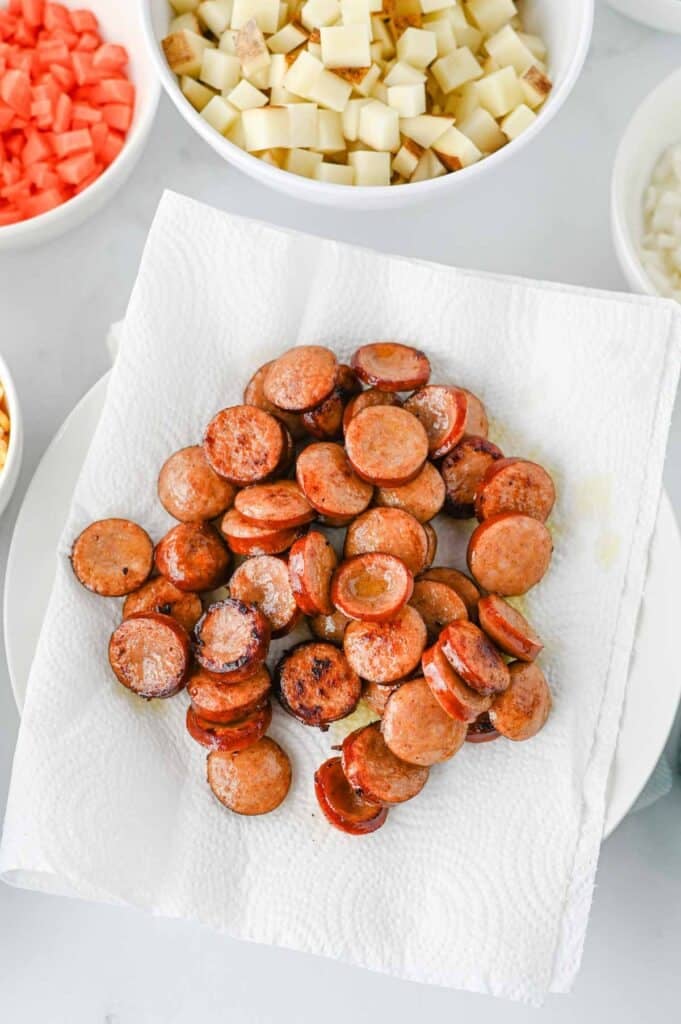 cooked kielbasa slices on a paper towel lined plate