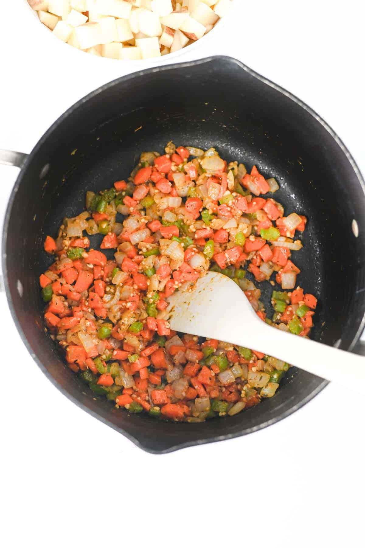 cooked veggies in a soup pot