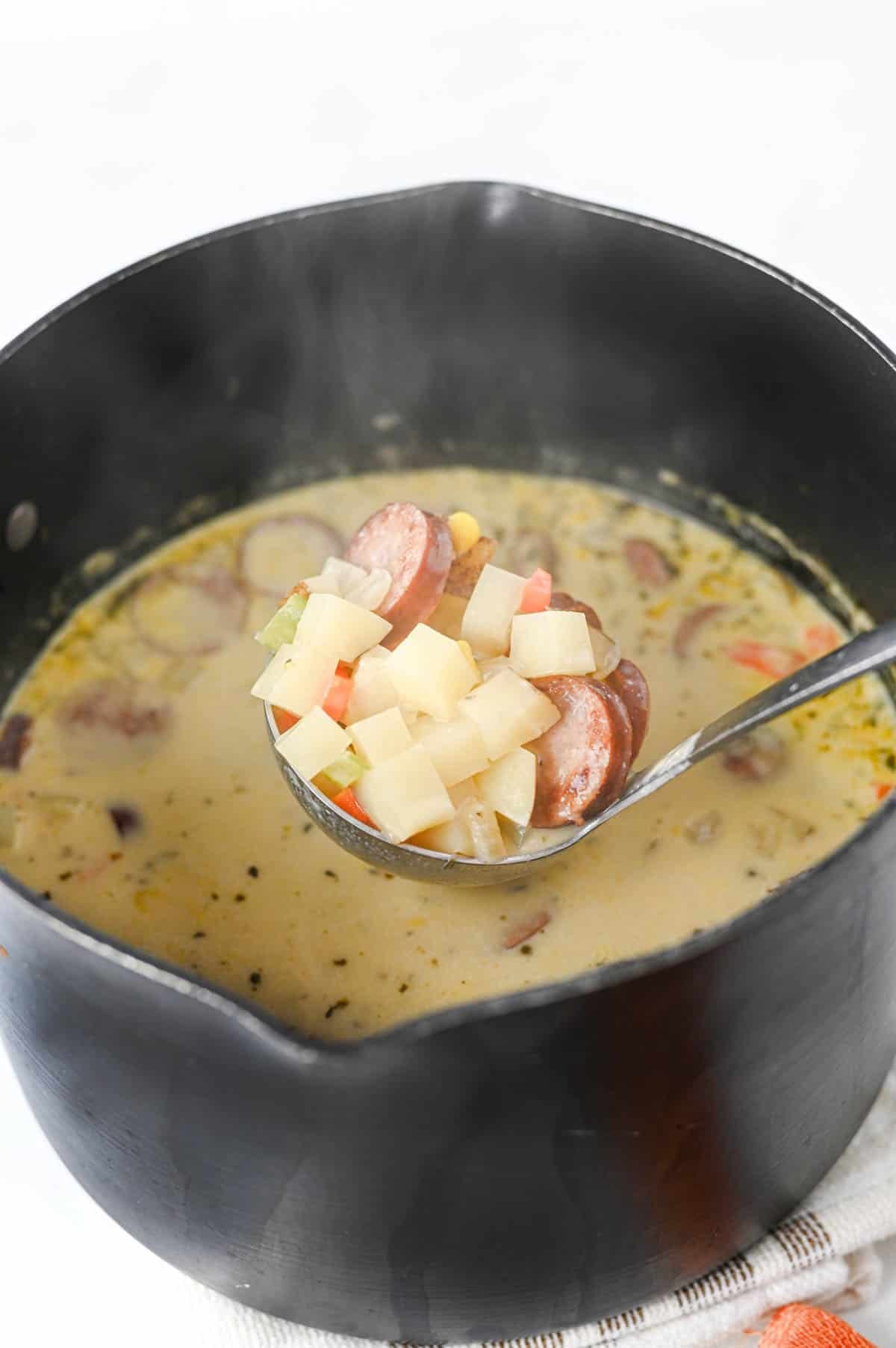 This Kielbasa Potato Soup is a hearty, creamy comfort food dinner loaded with smoky sausage, tender potatoes, carrots, celery, corn, and savory flavor. If you're searching for an Easy Kielbasa Soup, Creamy Potato Soup, Sausage Potato Soup, or cozy Fall Soup Recipe, this simple one pot meal is perfect for busy weeknights. Crispy kielbasa adds delicious smoky flavor to a rich chicken broth and heavy cream base, while russet potatoes make every spoonful filling and satisfying. This easy Potato Soup with Kielbasa is a great choice for cold weather dinners, family meals, and comforting Winter Soup Recipes. Add this creamy Kielbasa Sausage Soup to your list of Easy Soup Recipes, Hearty Soup Recipes, Potato Soup Recipes, and cozy dinner ideas. Save this recipe for a satisfying meal!
