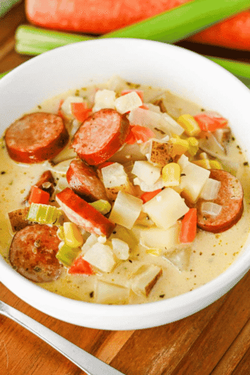 This Kielbasa Potato Soup is a hearty, creamy comfort food dinner loaded with smoky sausage, tender potatoes, carrots, celery, corn, and savory flavor. If you're searching for an Easy Kielbasa Soup, Creamy Potato Soup, Sausage Potato Soup, or cozy Fall Soup Recipe, this simple one pot meal is perfect for busy weeknights. Crispy kielbasa adds delicious smoky flavor to a rich chicken broth and heavy cream base, while russet potatoes make every spoonful filling and satisfying. This easy Potato Soup with Kielbasa is a great choice for cold weather dinners, family meals, and comforting Winter Soup Recipes. Add this creamy Kielbasa Sausage Soup to your list of Easy Soup Recipes, Hearty Soup Recipes, Potato Soup Recipes, and cozy dinner ideas. Save this recipe for a satisfying meal!