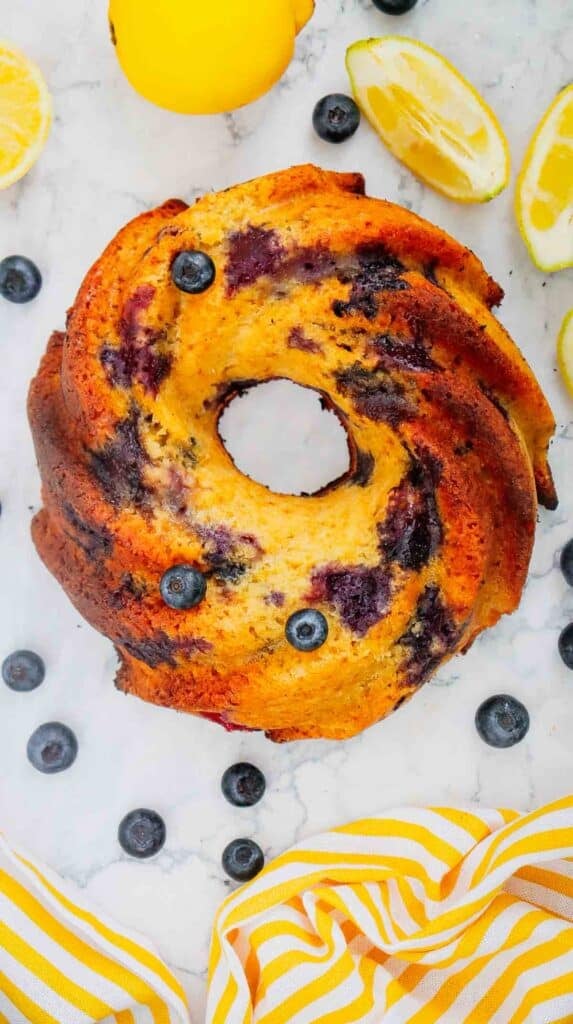 This Lemon Blueberry Bundt Cake is a moist, fluffy dessert bursting with juicy blueberries and fresh lemon flavor in every bite. If you’re searching for an Easy Lemon Blueberry Bundt Cake, Blueberry Lemon Cake, Lemon Bundt Cake Recipe, or Fresh Blueberry Dessert, this simple homemade cake is a must-try. Greek yogurt keeps the cake tender and moist while lemon zest adds the perfect bright citrus flavor. A sweet powdered sugar glaze finishes this beautiful Blueberry Bundt Cake and makes it perfect for spring baking, Easter dessert, Mother’s Day brunch, summer parties, potlucks, or afternoon coffee. Save this Lemon Blueberry Cake Recipe when you need Easy Bundt Cake Recipes, Lemon Desserts, Blueberry Desserts, Spring Cake Recipes, or a delicious dessert using fresh blueberries!