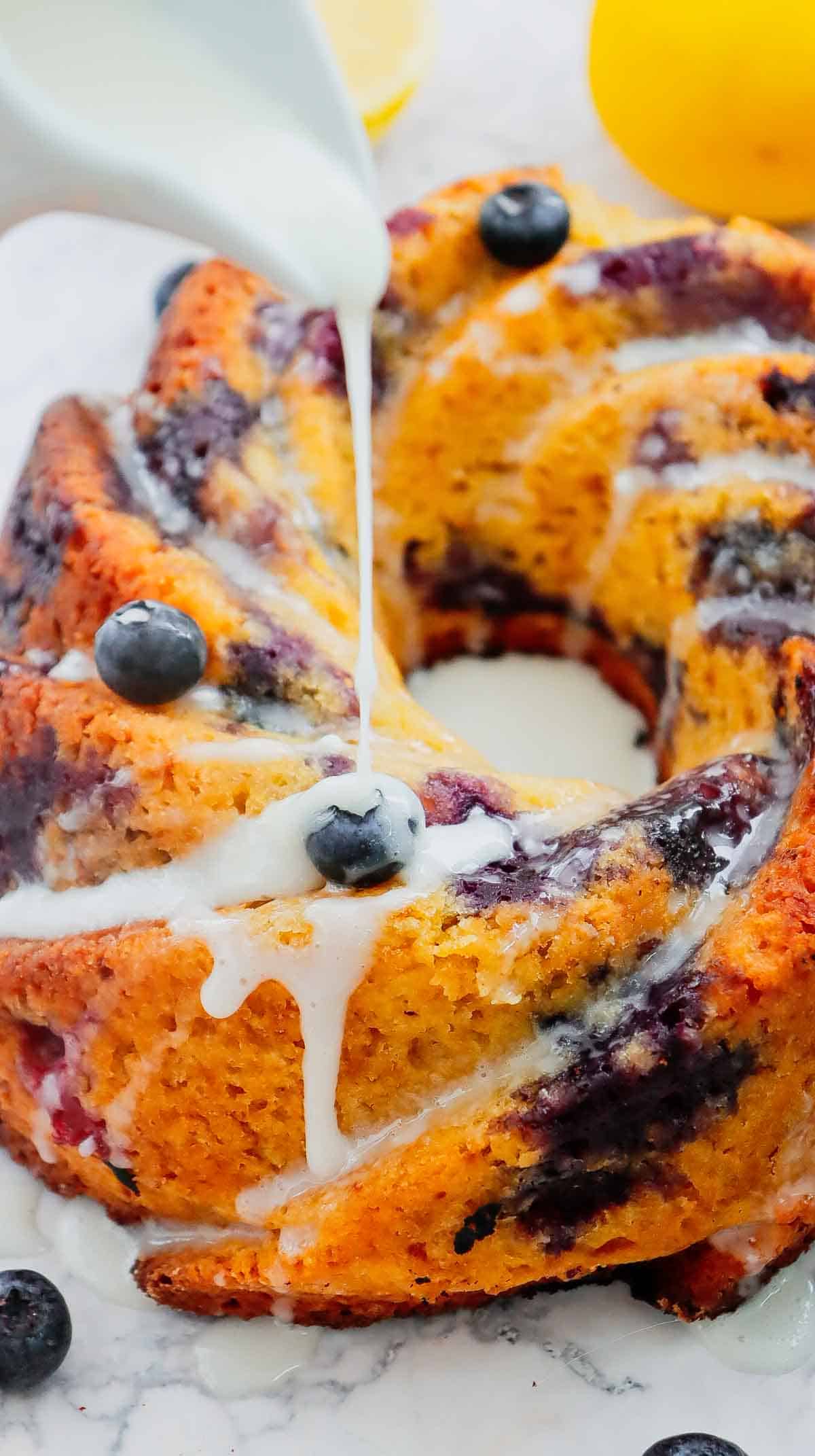 This Lemon Blueberry Bundt Cake is a moist, fluffy dessert bursting with juicy blueberries and fresh lemon flavor in every bite. If you’re searching for an Easy Lemon Blueberry Bundt Cake, Blueberry Lemon Cake, Lemon Bundt Cake Recipe, or Fresh Blueberry Dessert, this simple homemade cake is a must-try. Greek yogurt keeps the cake tender and moist while lemon zest adds the perfect bright citrus flavor. A sweet powdered sugar glaze finishes this beautiful Blueberry Bundt Cake and makes it perfect for spring baking, Easter dessert, Mother’s Day brunch, summer parties, potlucks, or afternoon coffee. Save this Lemon Blueberry Cake Recipe when you need Easy Bundt Cake Recipes, Lemon Desserts, Blueberry Desserts, Spring Cake Recipes, or a delicious dessert using fresh blueberries!