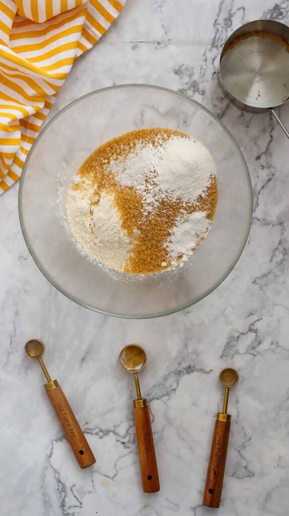 salt, baking powder and baking soda on top of brown sugar and flour in a mixing bowl