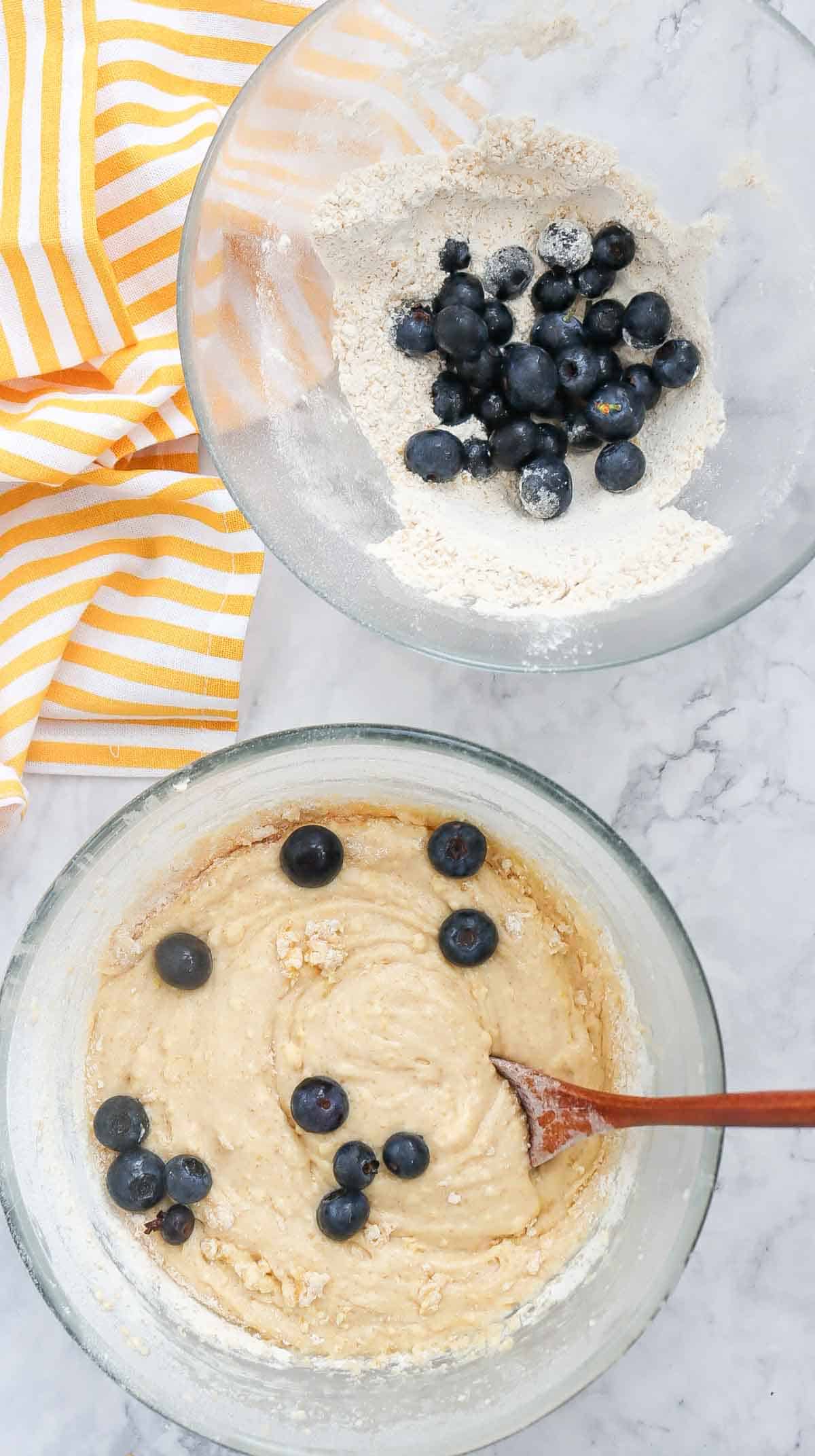 blueberries being added to bowl with cake batter
