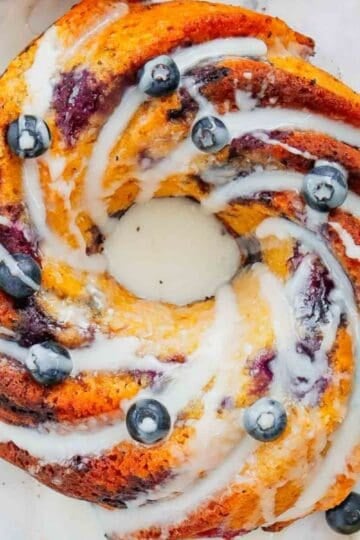 This Lemon Blueberry Bundt Cake is a moist, fluffy dessert bursting with juicy blueberries and fresh lemon flavor in every bite. If you’re searching for an Easy Lemon Blueberry Bundt Cake, Blueberry Lemon Cake, Lemon Bundt Cake Recipe, or Fresh Blueberry Dessert, this simple homemade cake is a must-try. Greek yogurt keeps the cake tender and moist while lemon zest adds the perfect bright citrus flavor. A sweet powdered sugar glaze finishes this beautiful Blueberry Bundt Cake and makes it perfect for spring baking, Easter dessert, Mother’s Day brunch, summer parties, potlucks, or afternoon coffee. Save this Lemon Blueberry Cake Recipe when you need Easy Bundt Cake Recipes, Lemon Desserts, Blueberry Desserts, Spring Cake Recipes, or a delicious dessert using fresh blueberries!