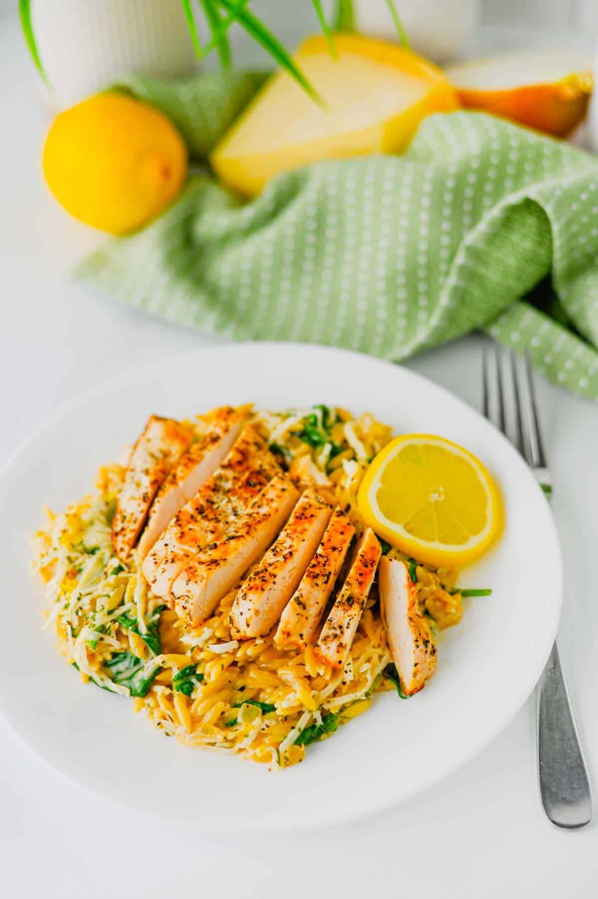 This Lemon Chicken Orzo is the perfect easy dinner when you’re craving creamy comfort food with a fresh, zesty twist! Tender seasoned chicken breast is served over creamy Parmesan orzo with baby spinach, garlic, Italian seasoning, heavy cream, fresh lemon juice and lemon zest. This easy Lemon Chicken Orzo Recipe comes together in one skillet in about 30 minutes, making it perfect for busy weeknights and simple family dinners. If you love One Pan Chicken Recipes, Creamy Chicken Orzo, Lemon Chicken Recipes and quick Orzo Dinner Recipes, this dish is a must-try. Serve this creamy Lemon Parmesan Chicken Orzo for an easy weeknight dinner, cozy family meal or simple date night at home. Save this easy chicken dinner recipe for the next time you need a flavorful meal everyone will love!