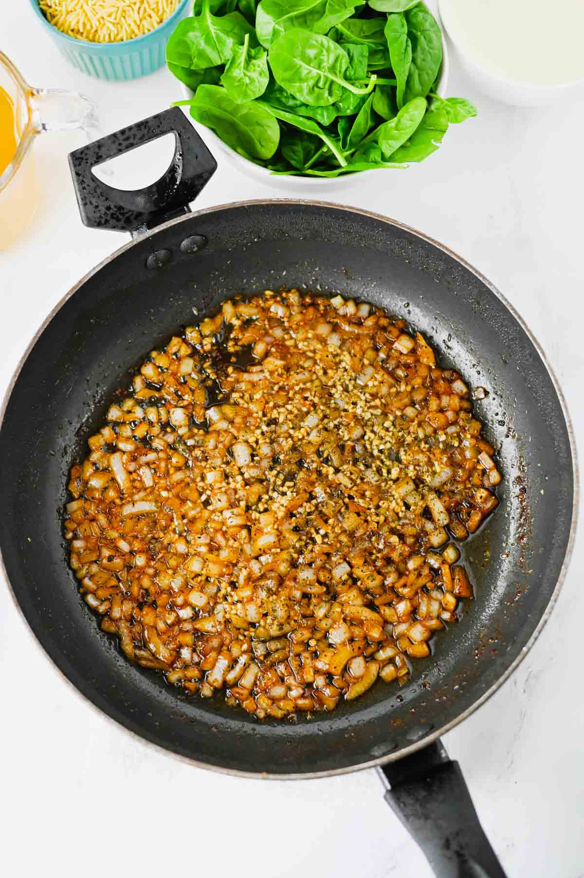 diced onions cooking in a skillet