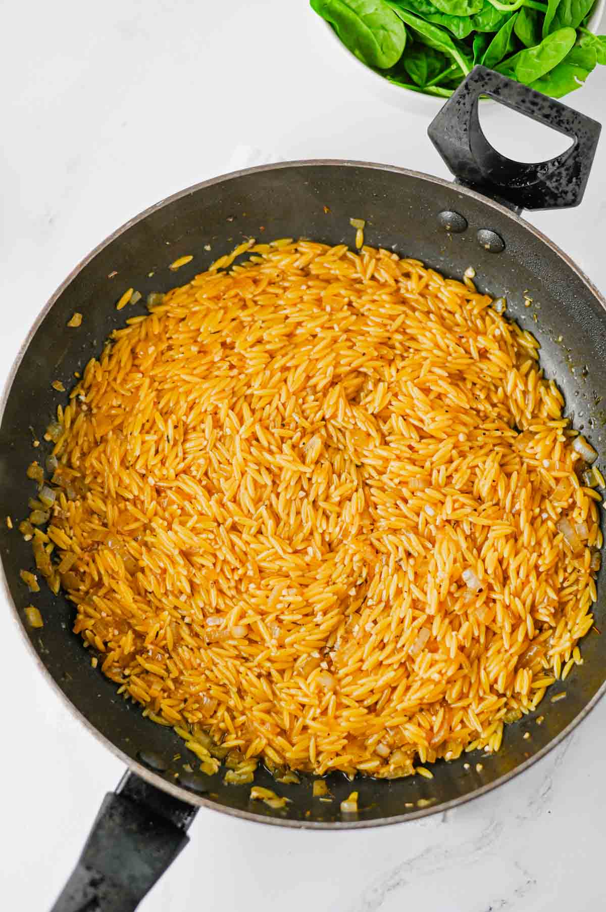 orzo cooking in a skillet